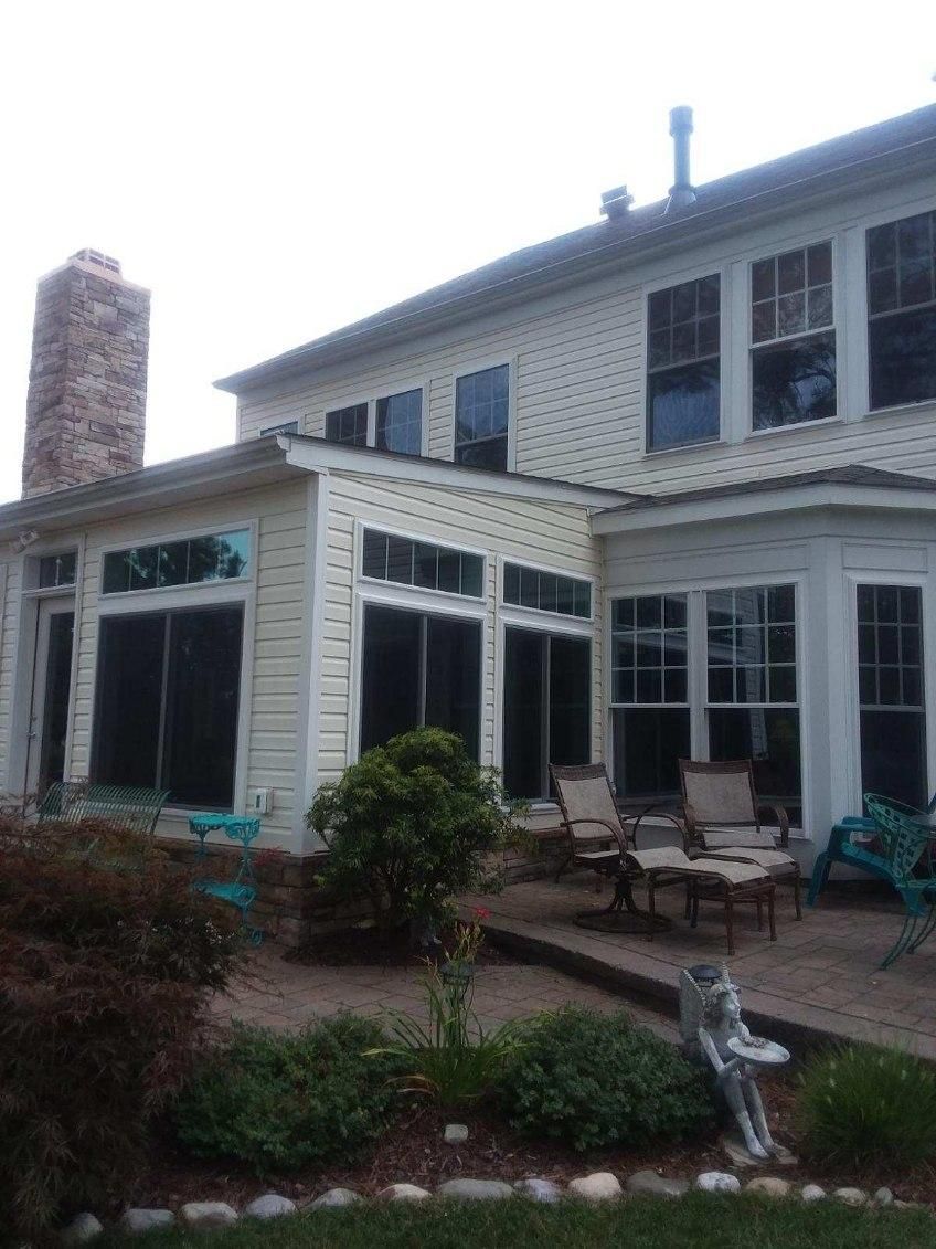 A large white house with a lot of windows and a patio