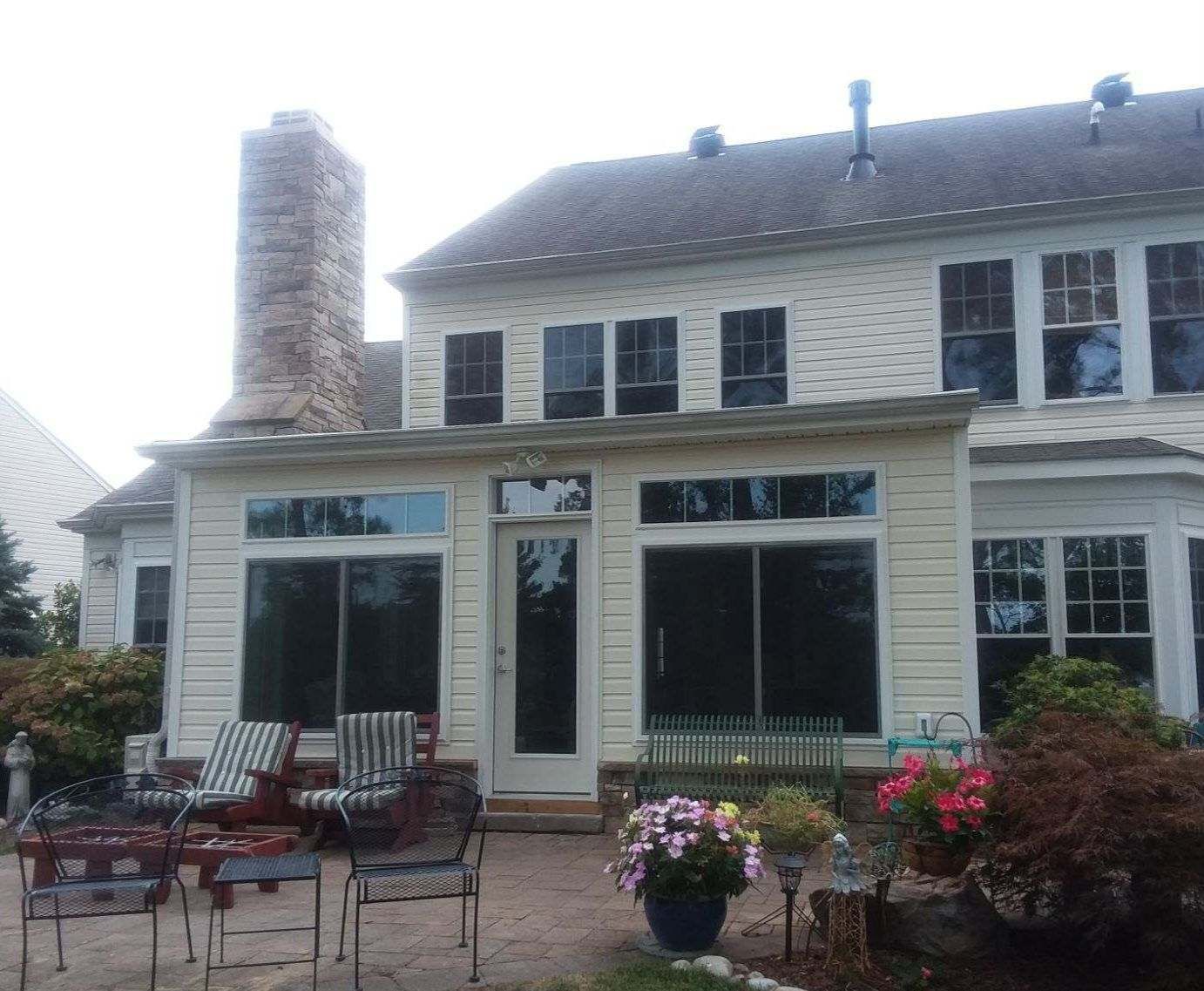 A large house with a lot of windows and a chimney