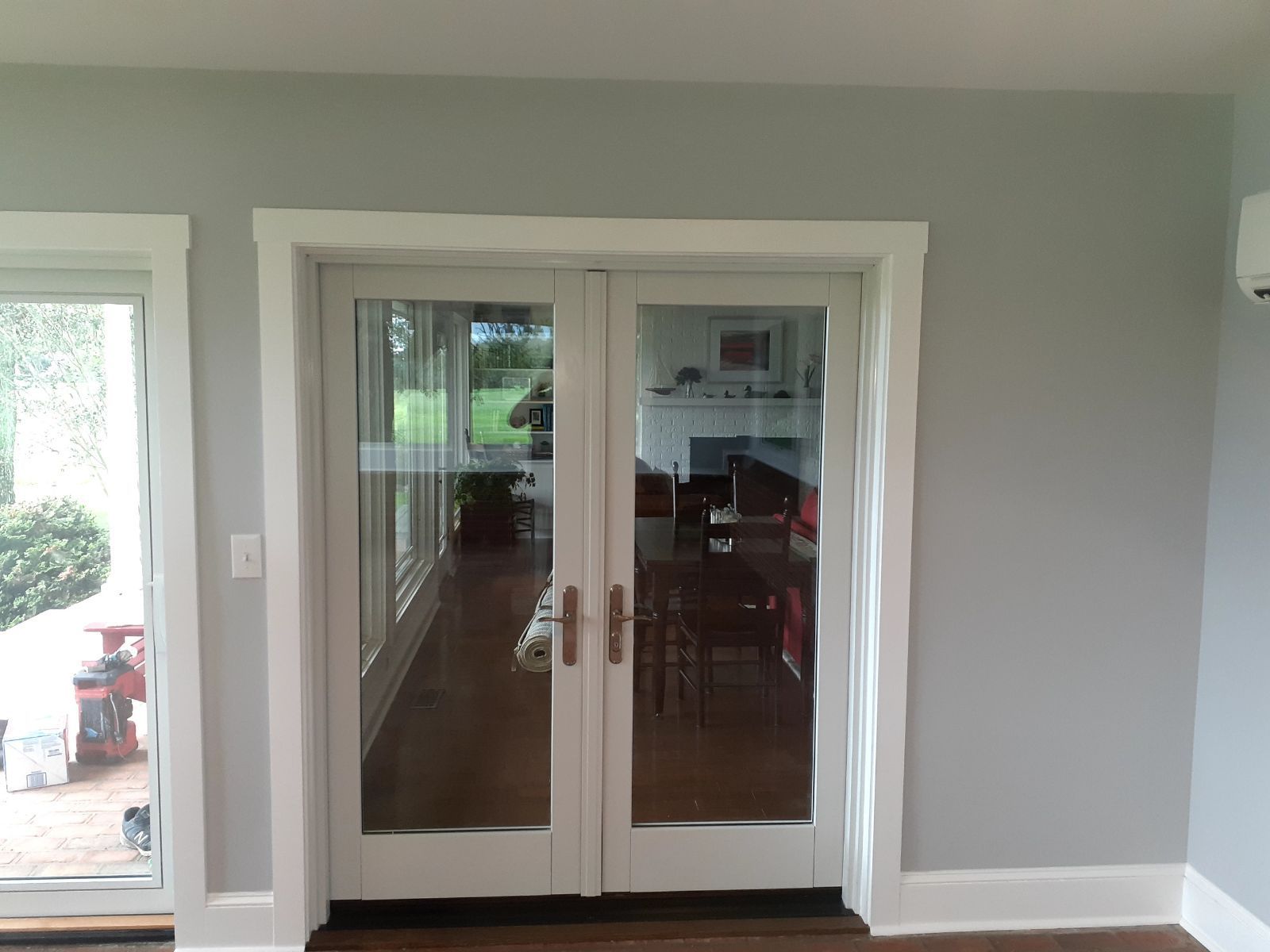 A living room with french doors and a fireplace