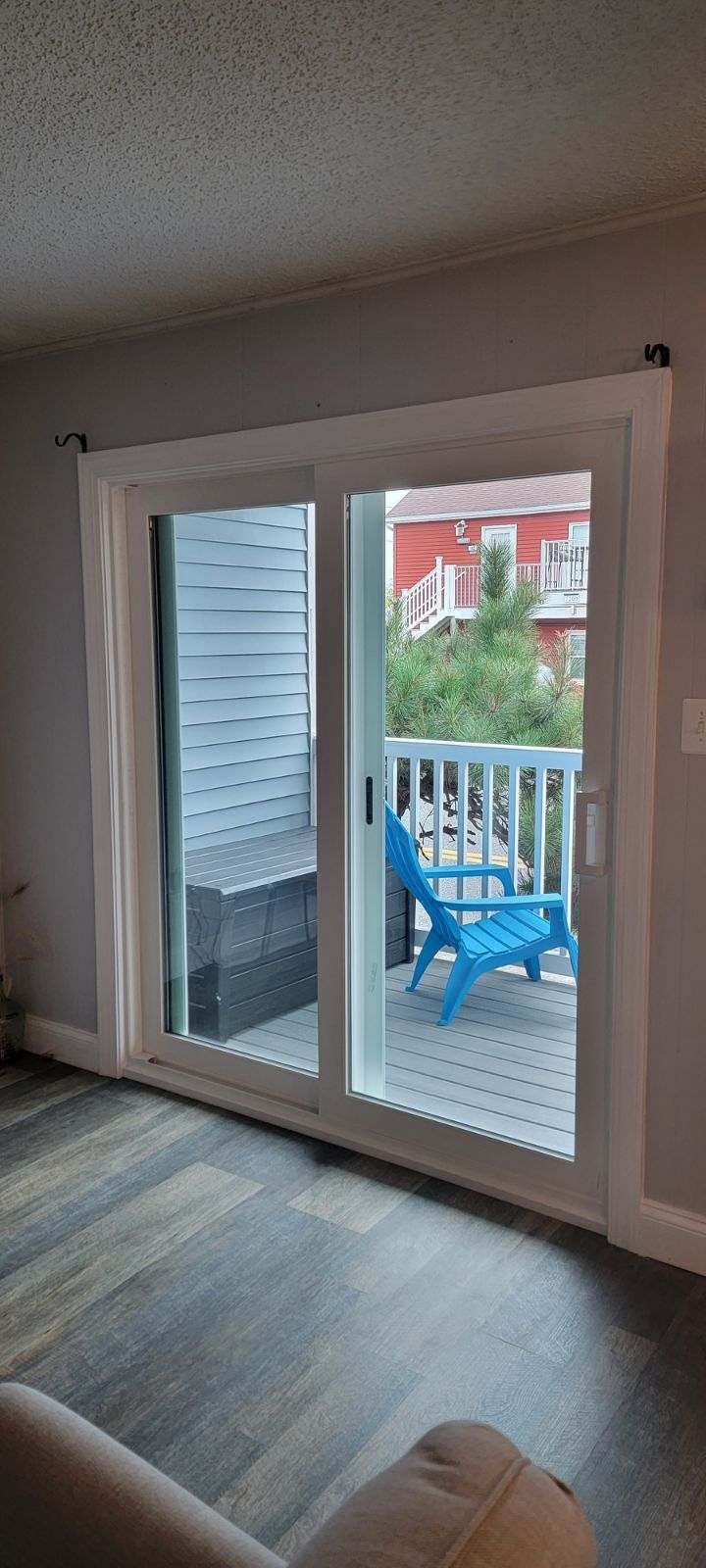 A living room with a sliding glass door leading to a balcony.