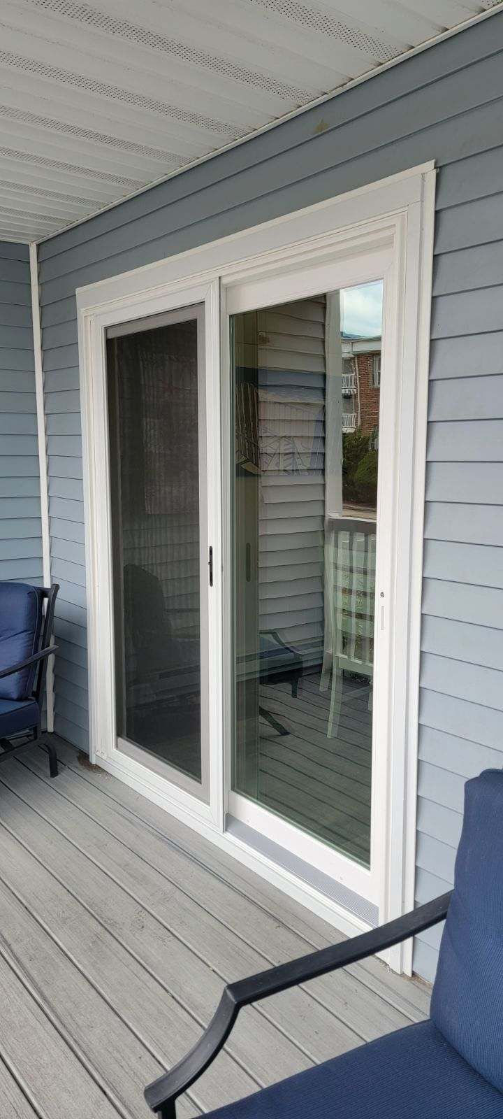 There is a sliding glass door on the side of the house.