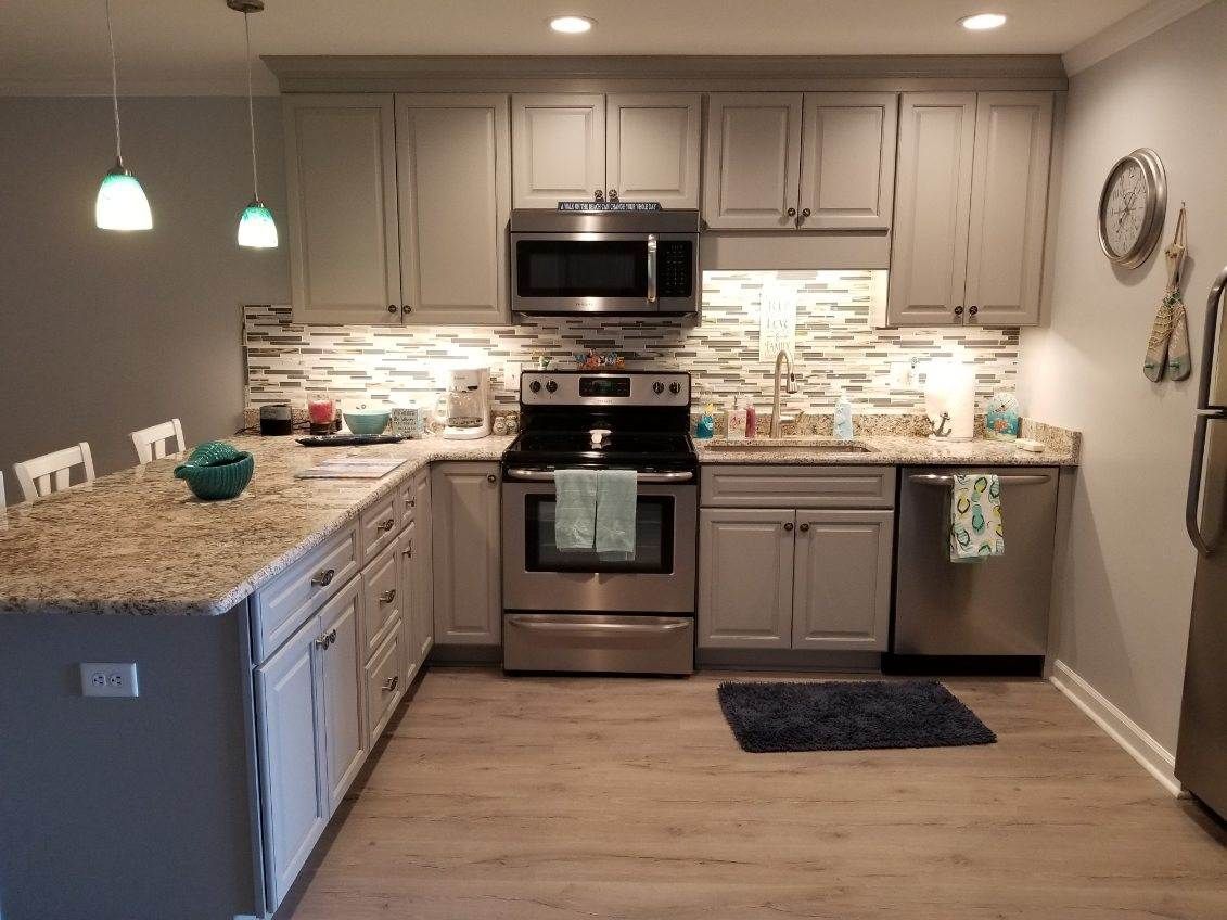 A kitchen with stainless steel appliances and granite counter tops.