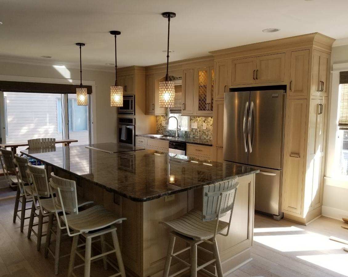A kitchen with stainless steel appliances and granite counter tops.