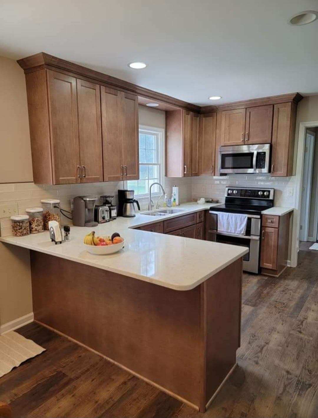 A kitchen with wooden cabinets and stainless steel appliances.