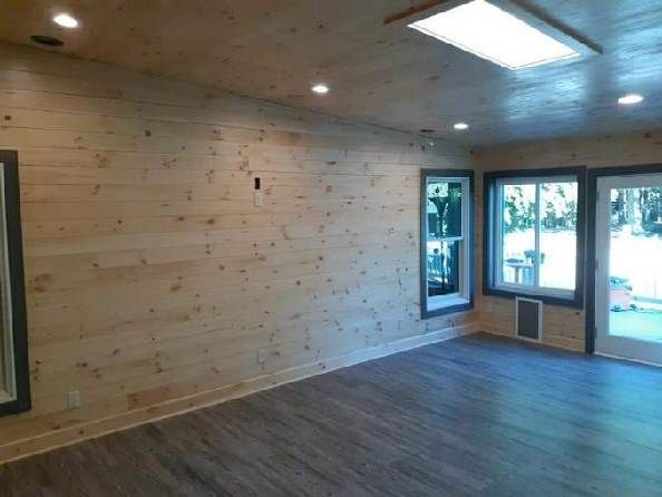 An empty room with wooden walls and a wooden floor.