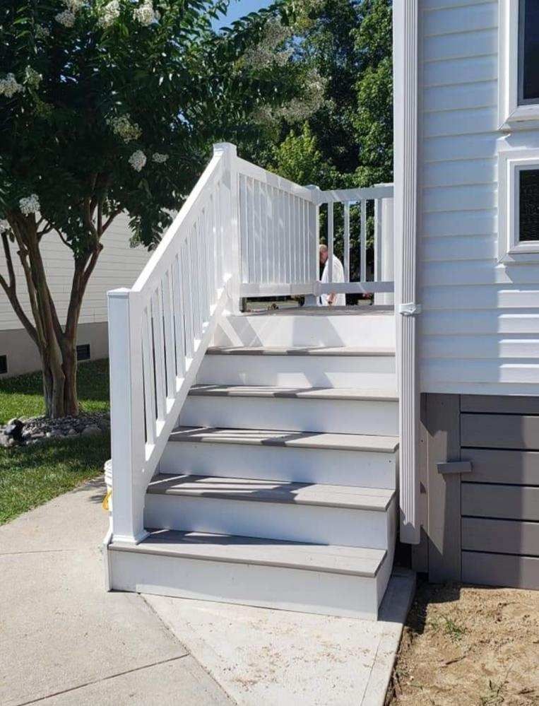 A white house with stairs leading up to it