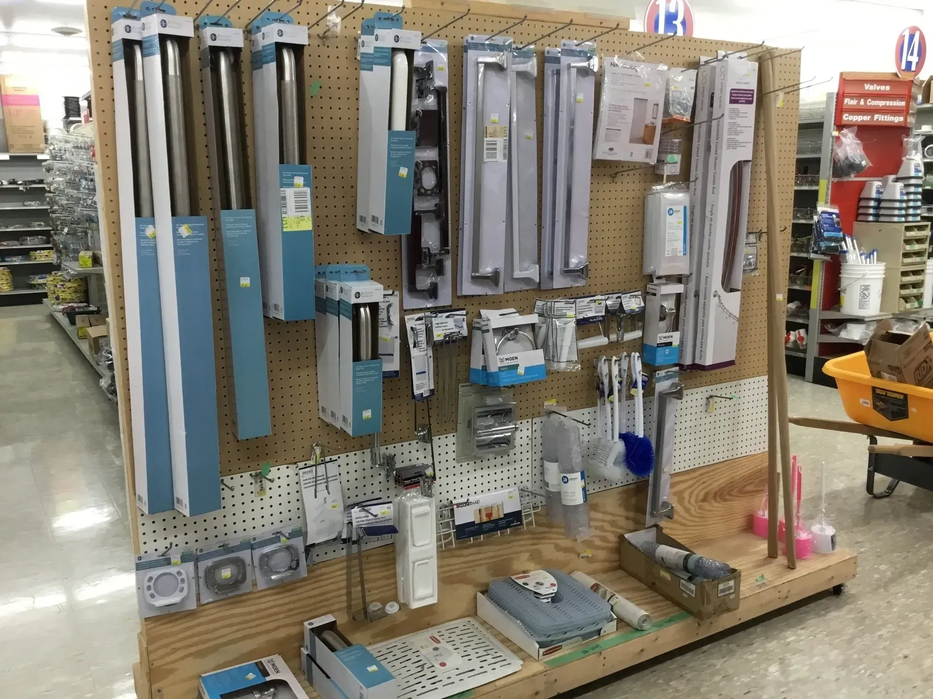 Pegboard display of assorted tools and hardware in a store aisle