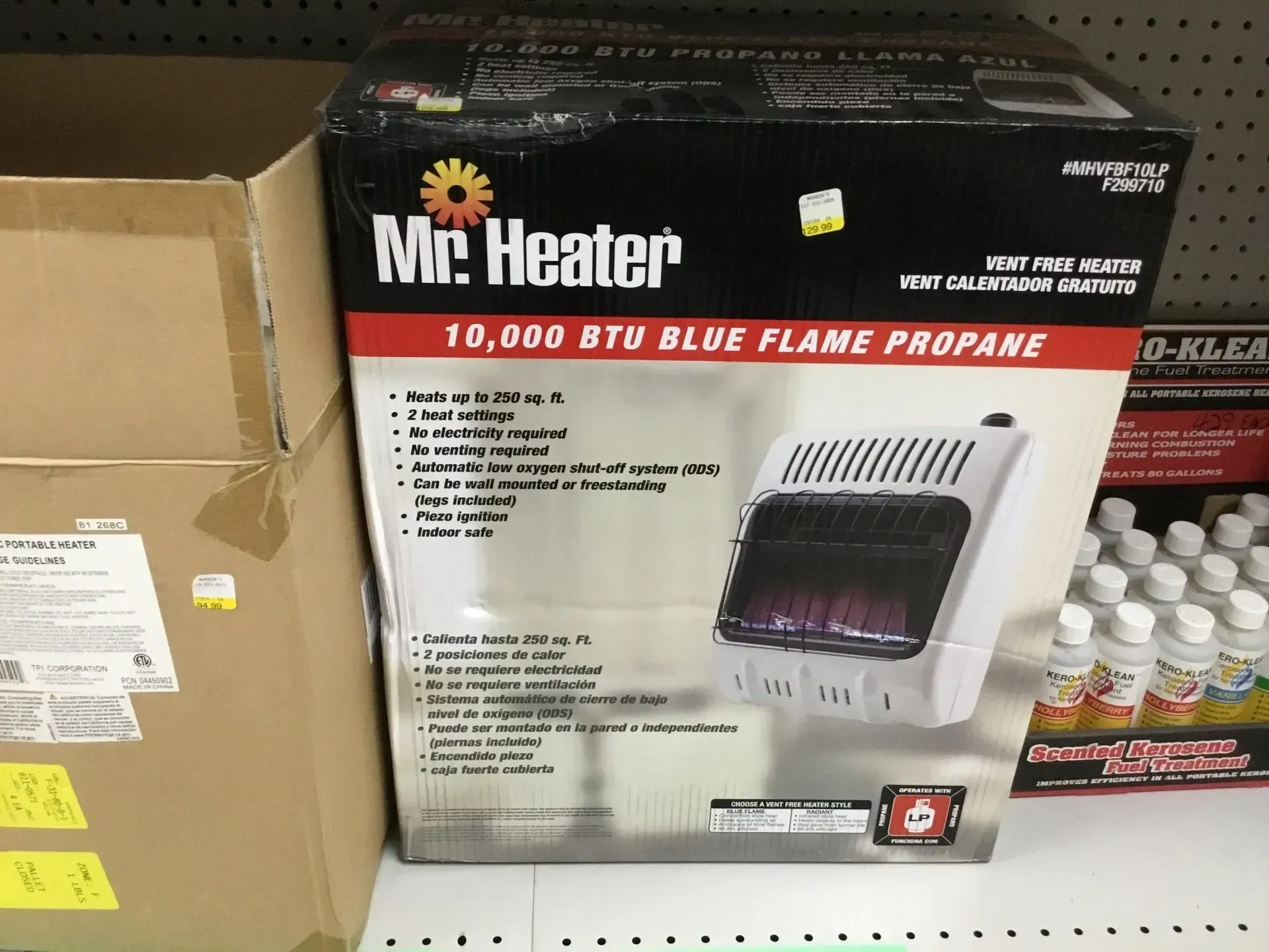Store shelf with Mr. Heater 10,000 BTU blue flame propane heater box and stacked propane cylinders