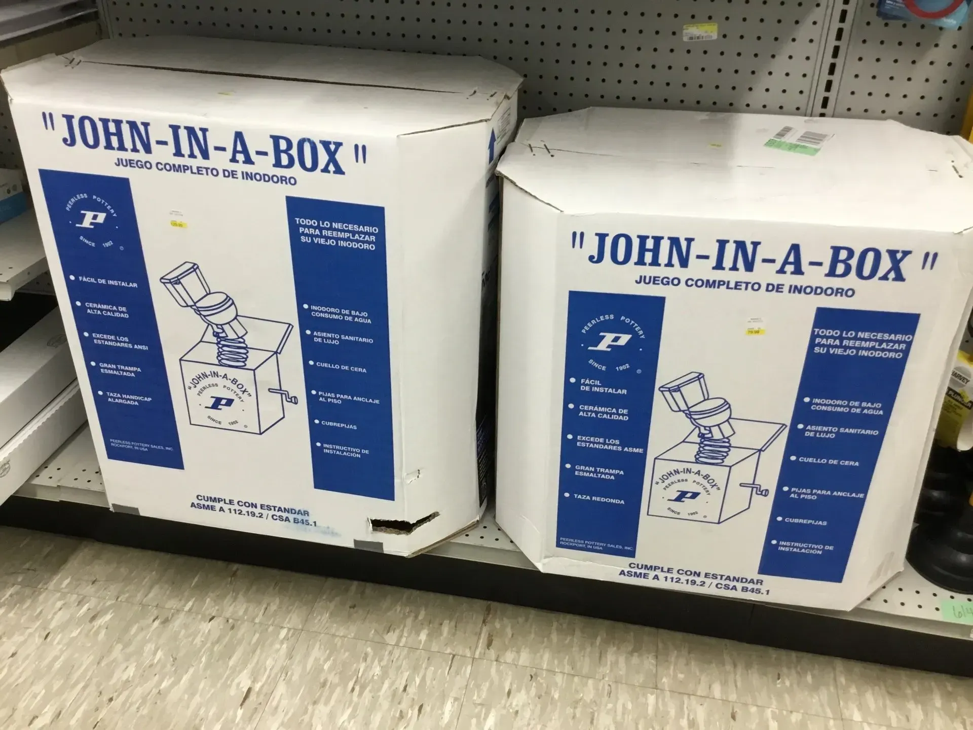 Two white John-in-a-Box toilet repair kits on a store shelf with blue labels