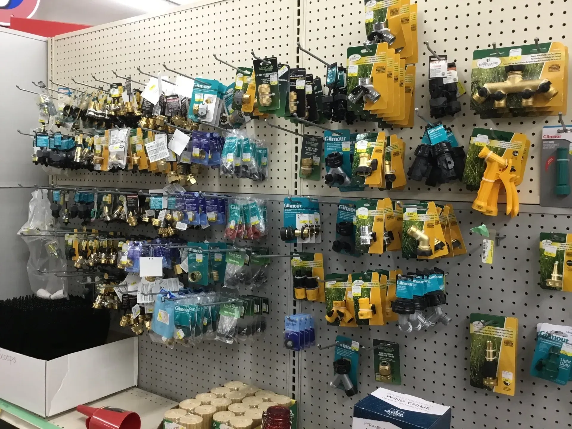 Pegboard display of assorted small toy/action figure packs in a store aisle