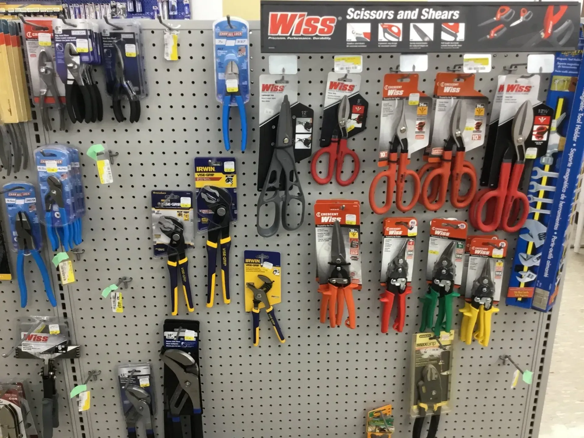 Hardware store display of assorted pliers, snips, and cutters on a pegboard wall