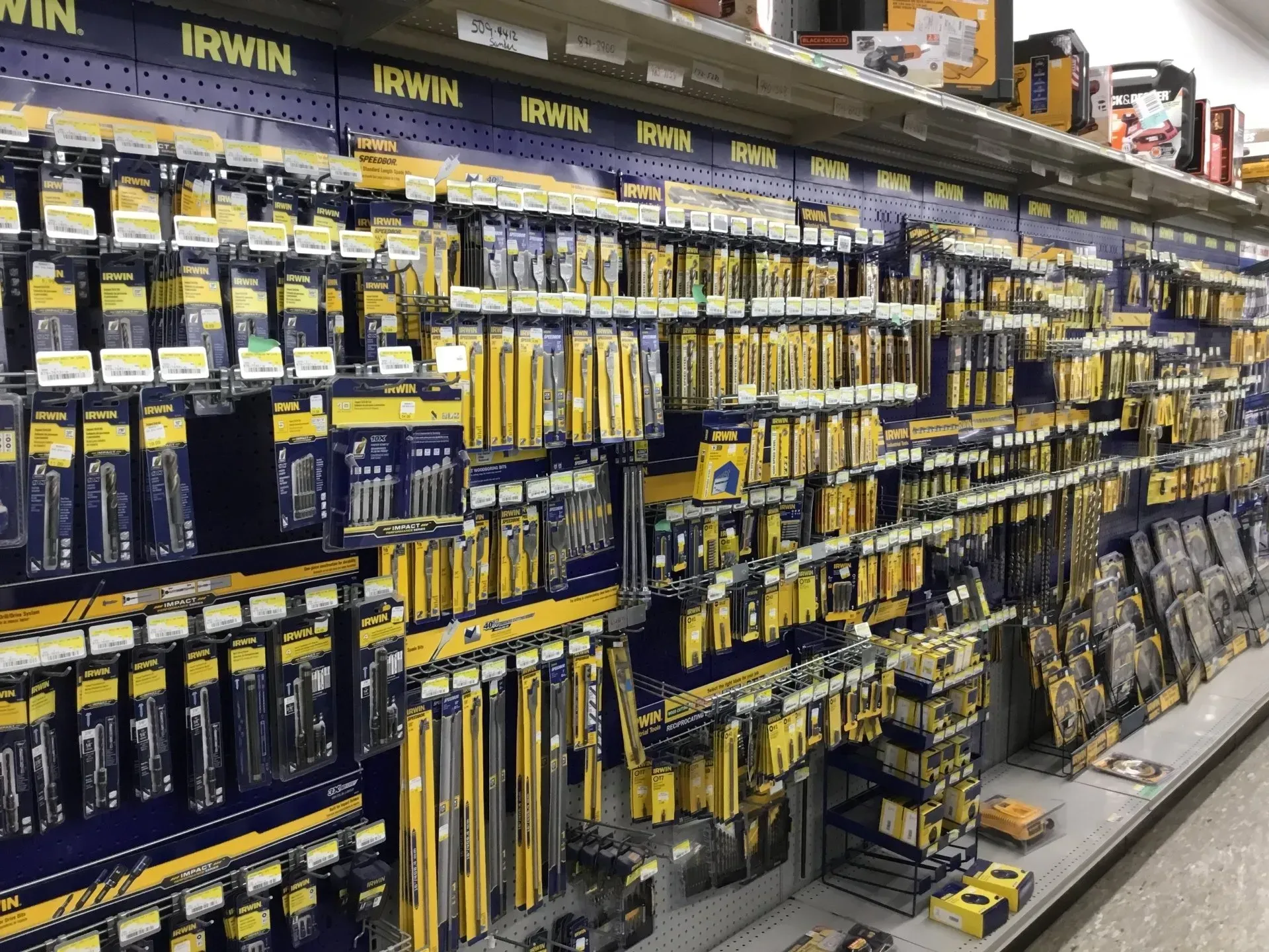 Hardware store aisle with rows of hanging Irwin tools and boxed products on shelves