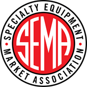 SEMA logo: white letters on red circle, encircled by text in a black and white border.