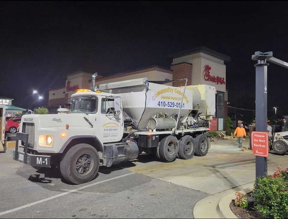 Concrete truck at Chick-fil-A restaurant, possibly for construction. Nighttime.