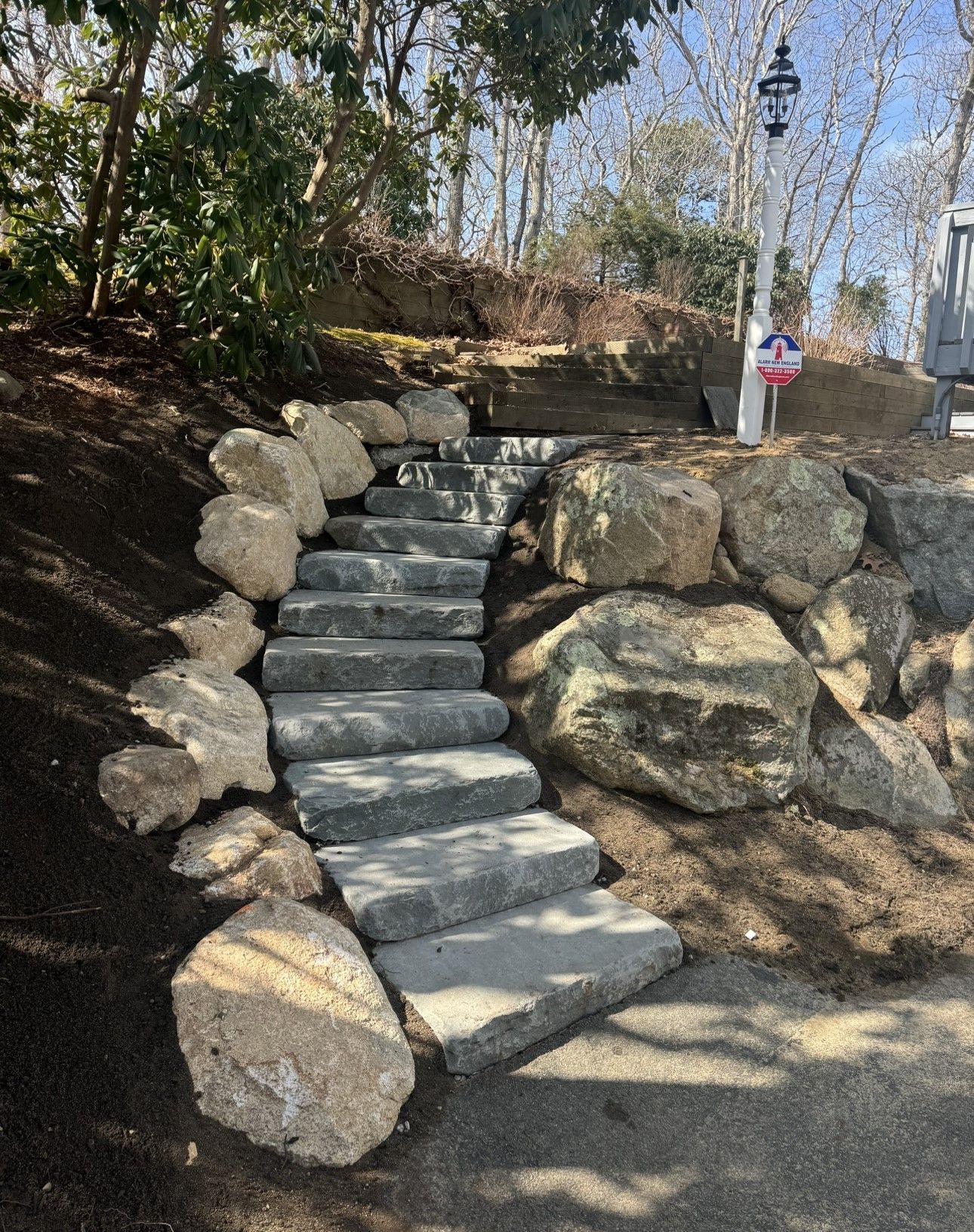 A set of stairs made of rocks leading up to a house.