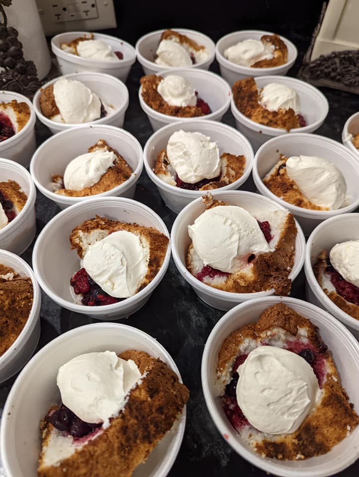 A table topped with bowls of desserts with ice cream on top.