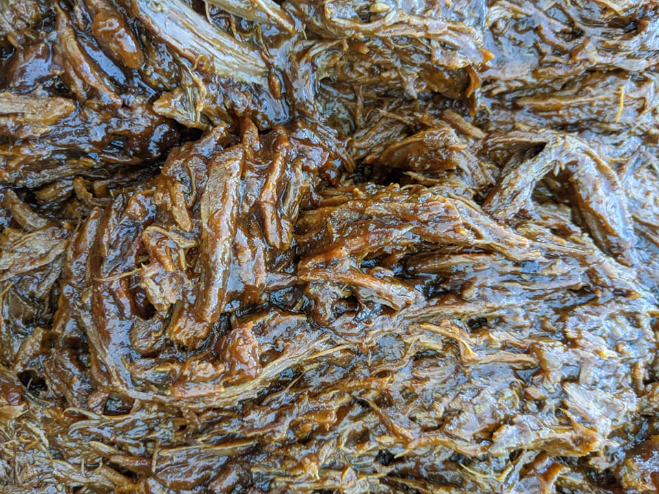 A close up of a pile of meat with sauce on it.