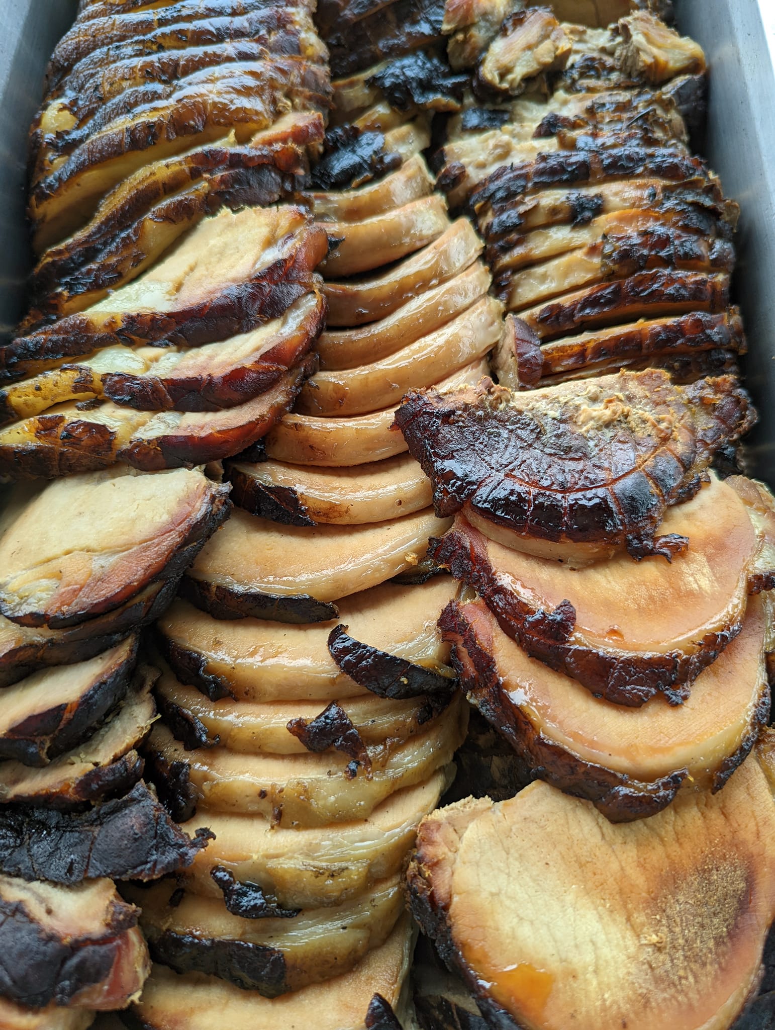 A close up of a tray of sliced meat.