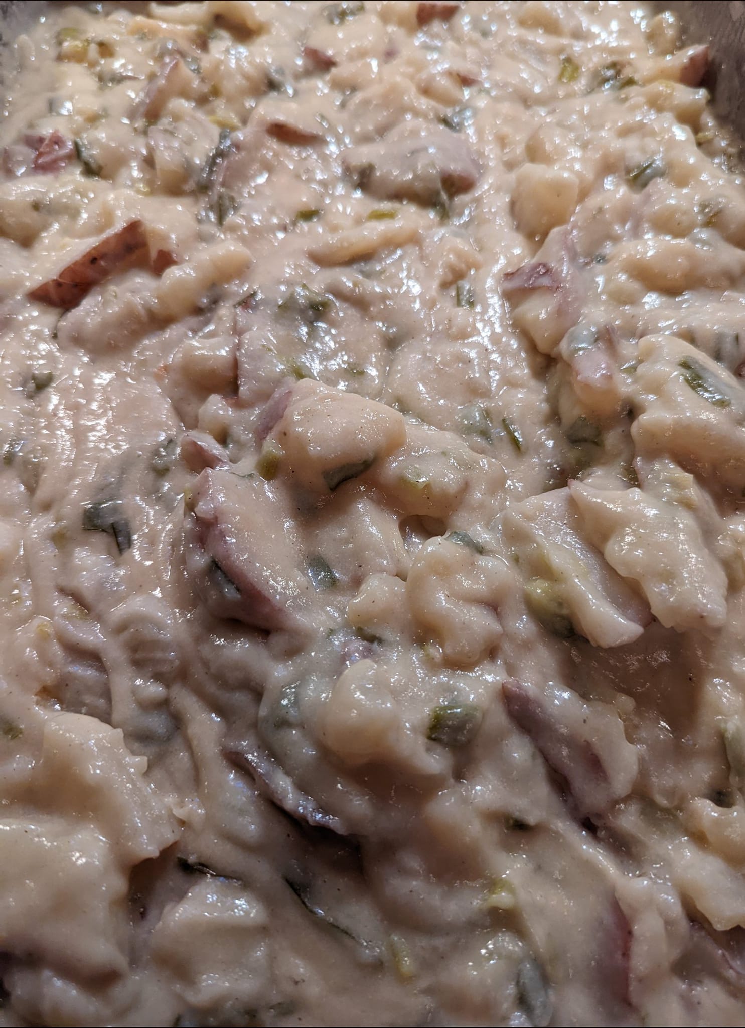 A close up of a casserole dish filled with rice and vegetables.