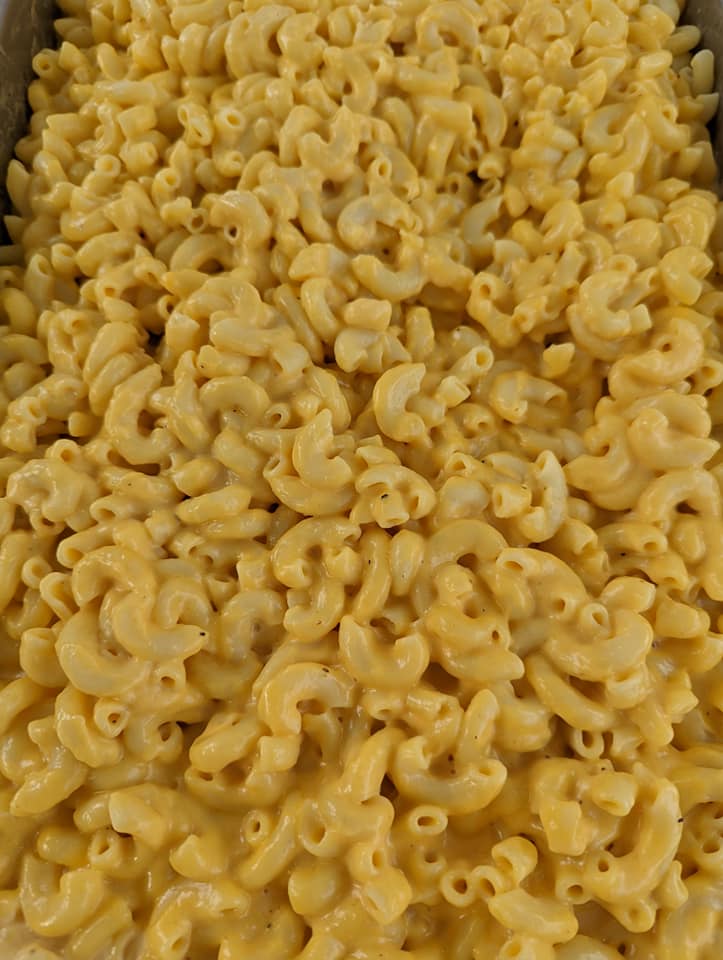 A close up of macaroni and cheese in a pan.