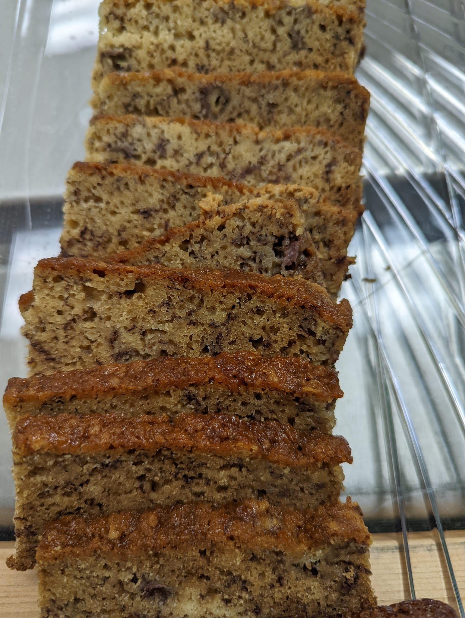 A loaf of banana bread is sitting on a cooling rack.
