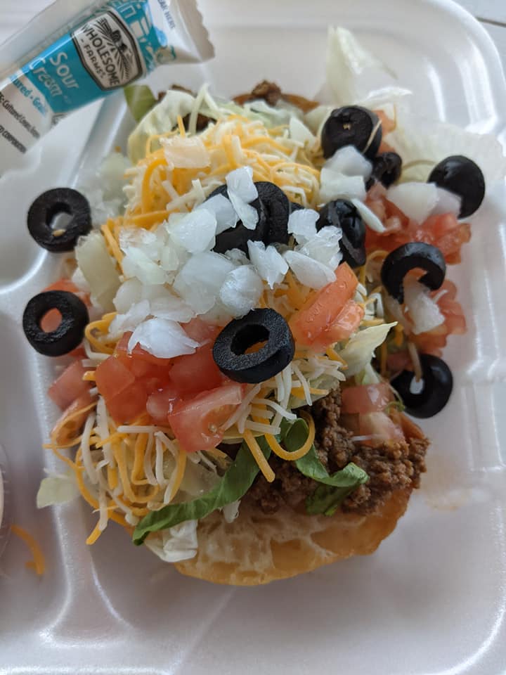 A close up of a taco salad on a styrofoam container.
