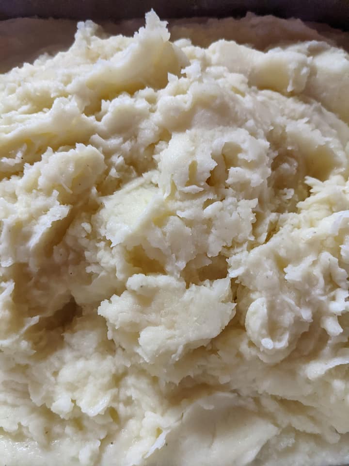 A close up of a pile of mashed potatoes on a table.