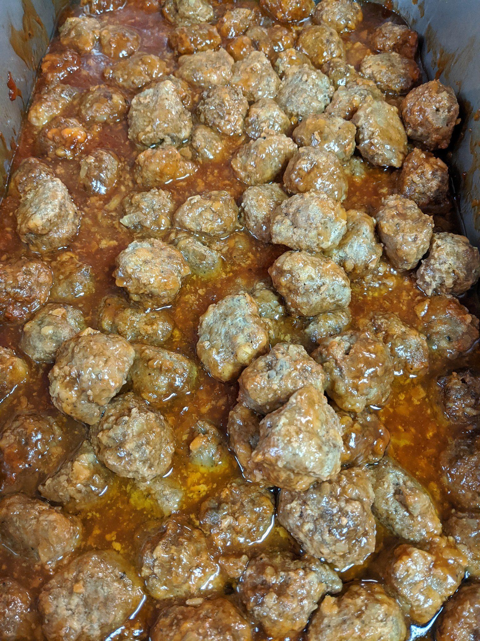 A casserole dish filled with meatballs and sauce.