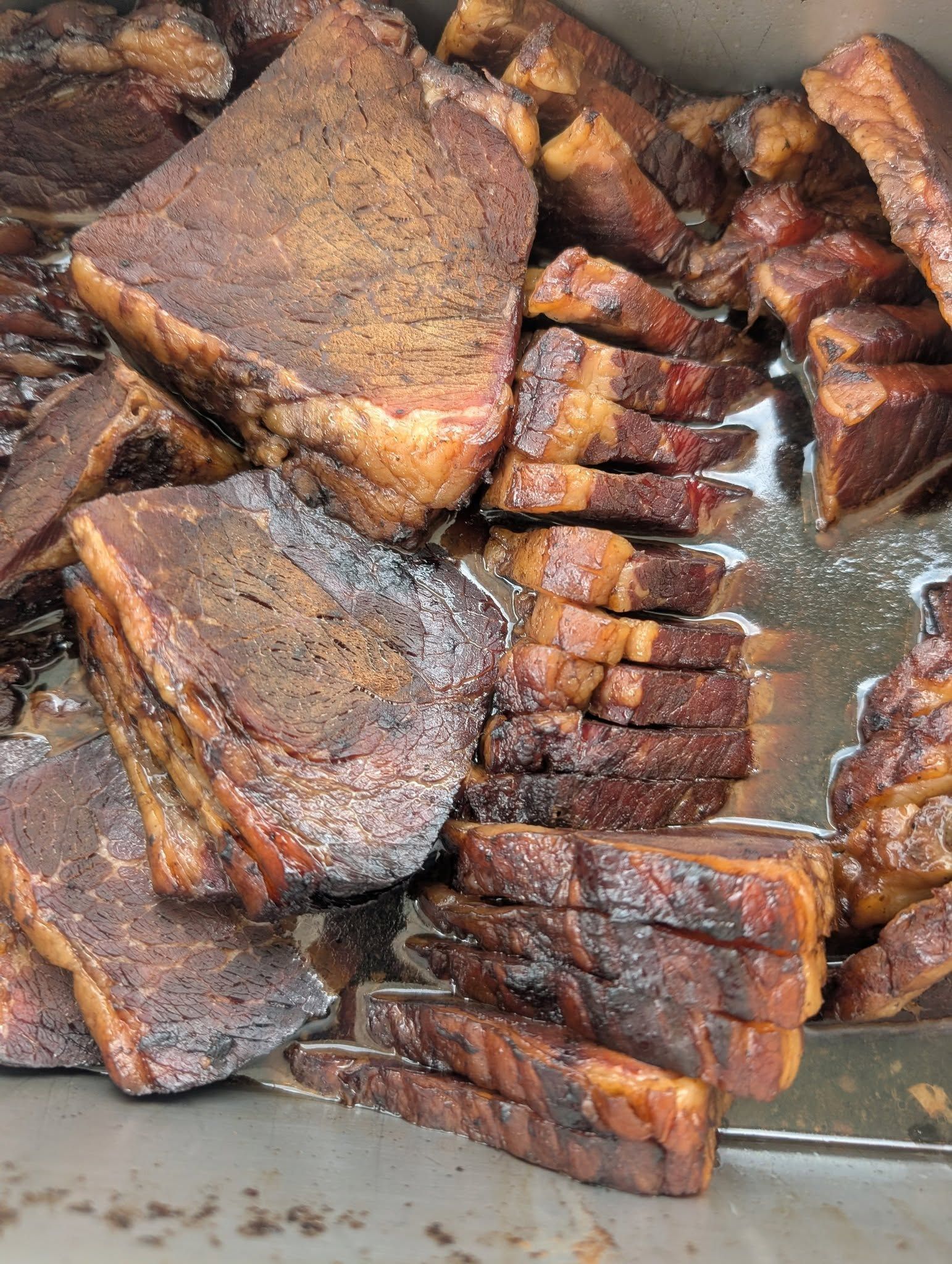 A pile of sliced meat is sitting on a table.