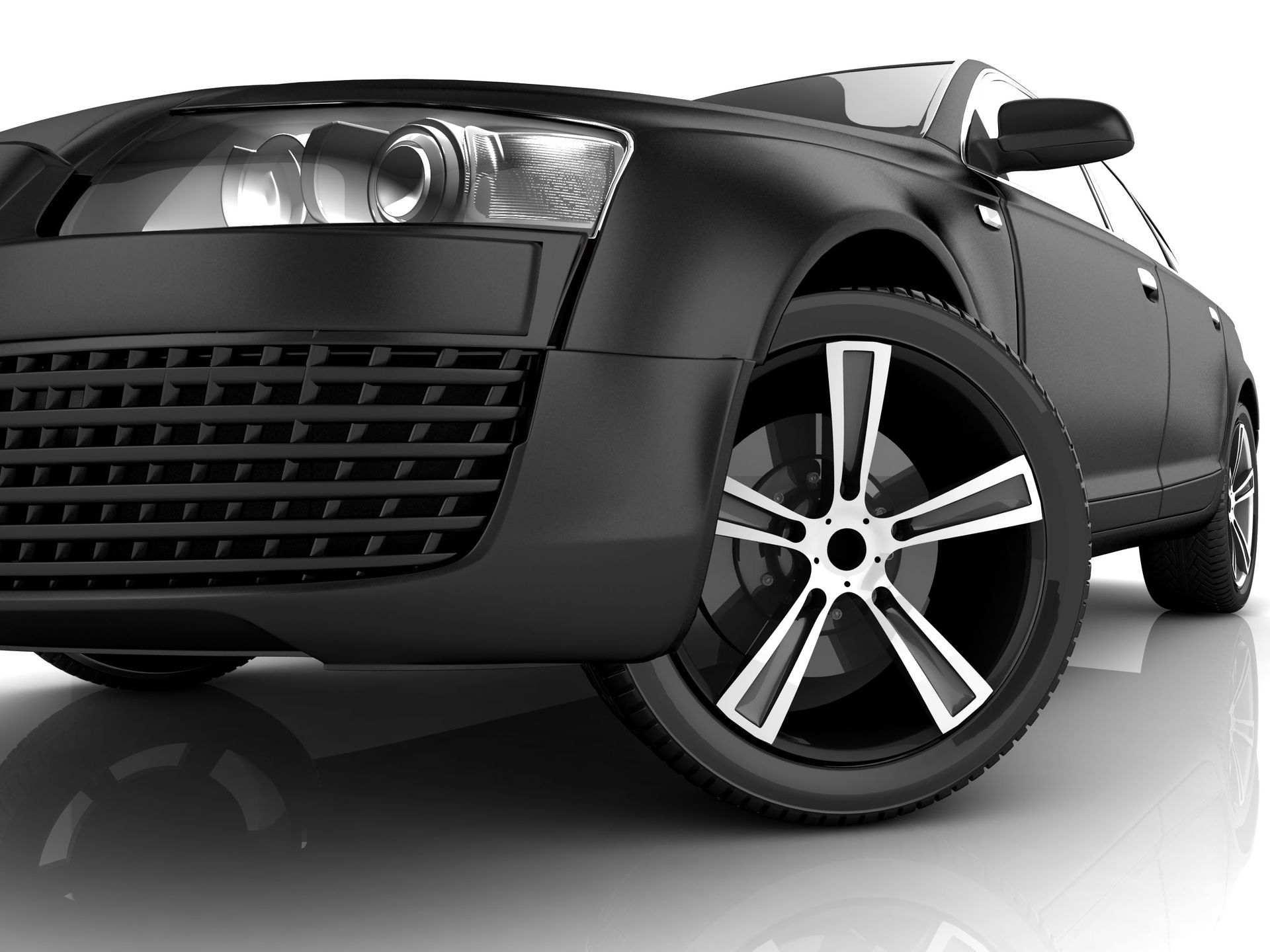 Black sports sedan on a white studio background, front-left view with alloy wheel visible