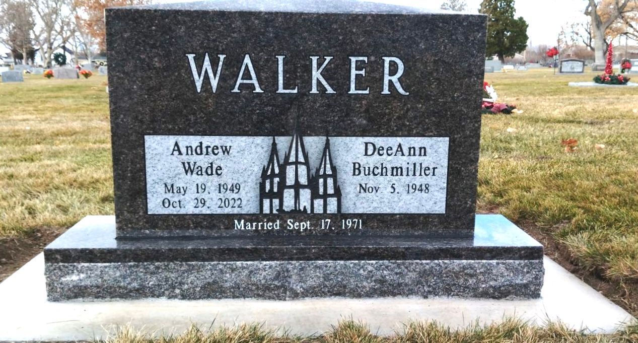 Grave of the Walker family. Black headstone with names, dates, and silhouette of a church building in a cemetery.