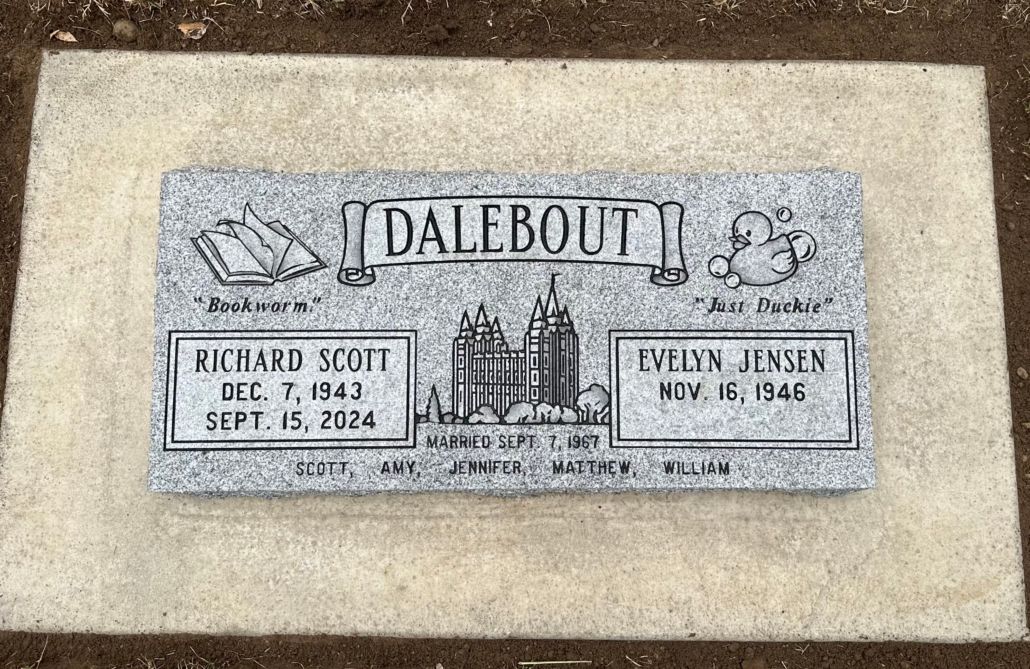 Gravestone for Dalebout family: Richard Scott (1942-2024) and Karen Jensen (1946-1998). Gray stone, etched with symbols.