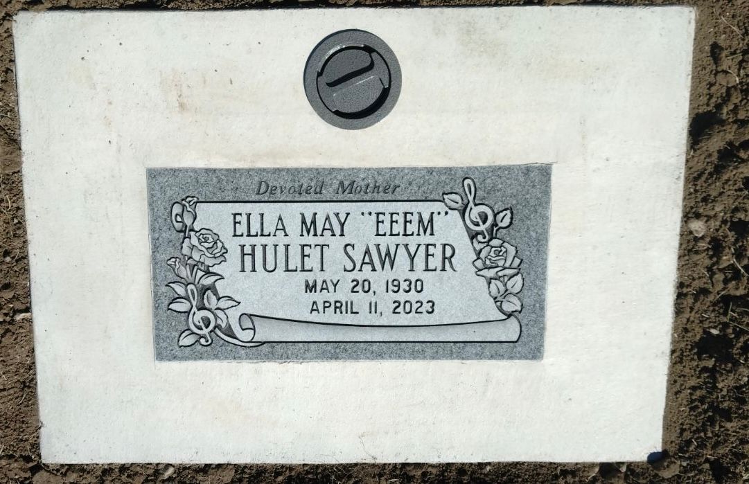 Headstone of Ella May E.E.M. Tulet Sawyer, born 1930, died 1973, with floral design.