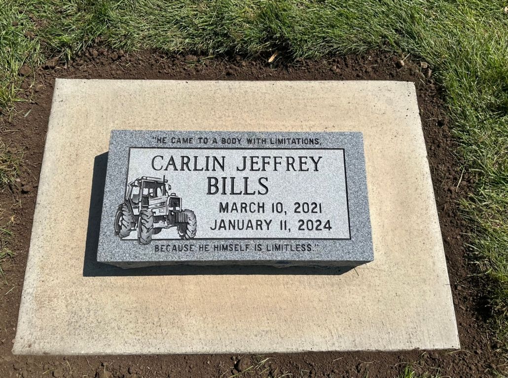Grave marker for Carlin Jeffrey Bills, with birth and death dates, and a tractor illustration.
