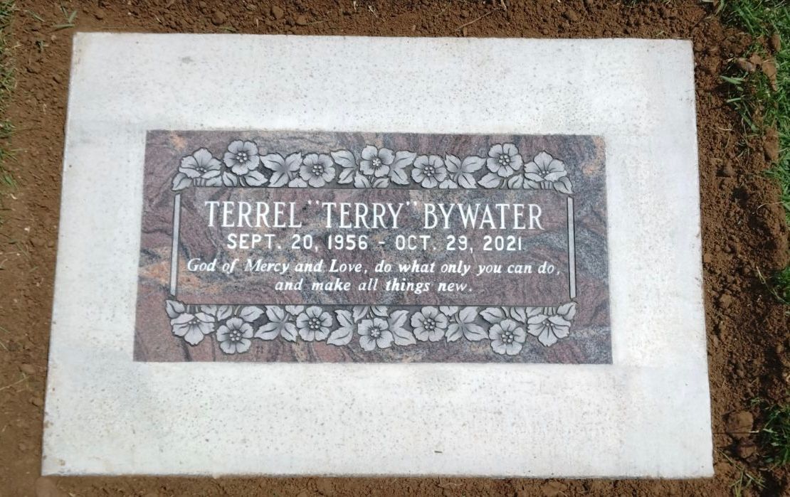 Grave marker for Terrel Terry Bywater: names, dates, a floral border, and a quote.