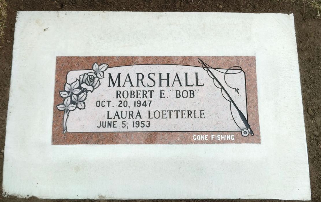 Gravestone of Robert E. Bob Marshall and Laura Loetterle, with fishing rod and flower illustration.