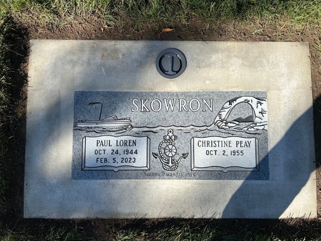 Grave of Kall Jines and Christine Hess, engraved names with birth and death dates, set in a concrete slab.