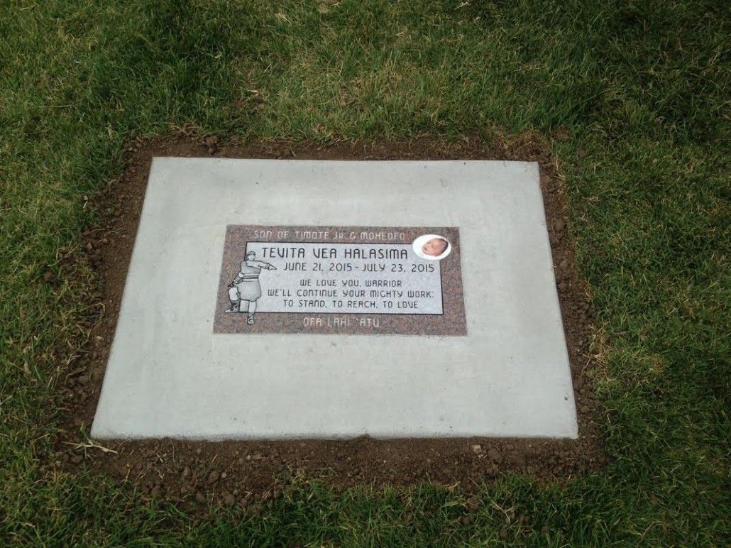 Grave marker with text Terry Kaye Lunquist and birth/death dates; set in a concrete square on green grass.