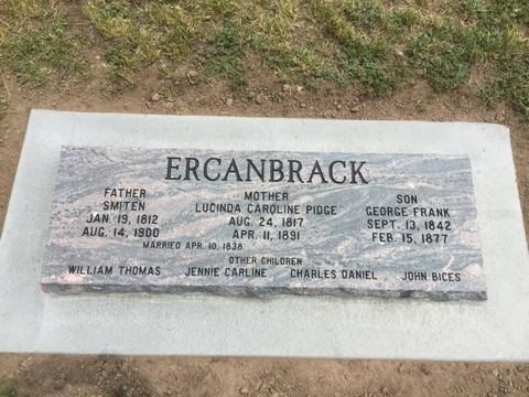 Gray granite headstone with ERCANBRACK in raised letters. 
