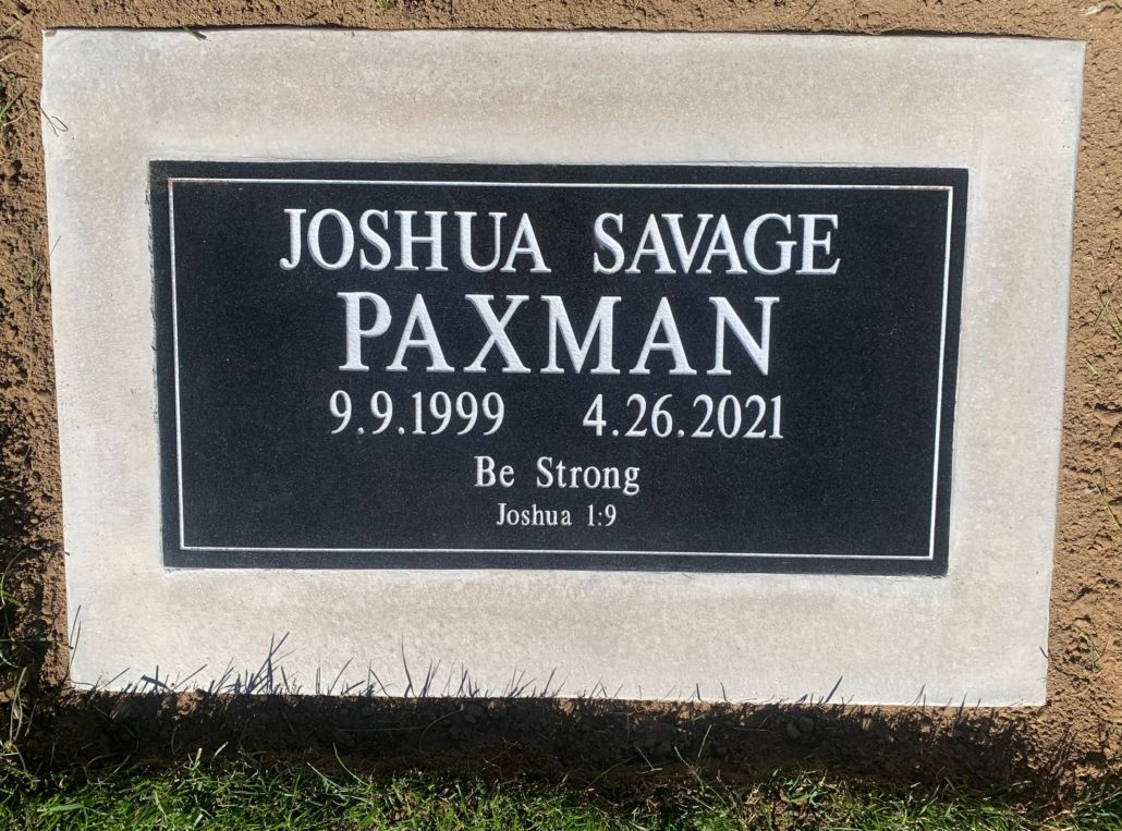 Headstone for Joshua Savage Paxman, black plaque with name, birth/death dates, and inscription Be Strong.
