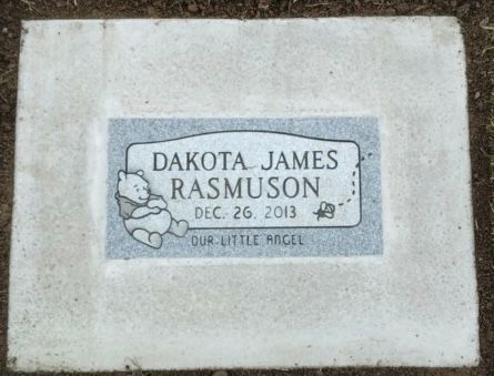 Grave marker for Dakota James Rasmuson. Includes birth date and Winnie the Pooh illustration.