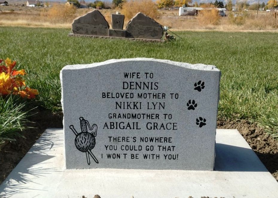 Tombstone in a cemetery, inscribed 