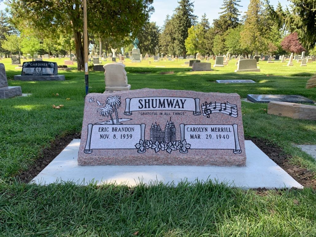Headstone in a cemetery with the name Shumway; pink granite with names and dates.