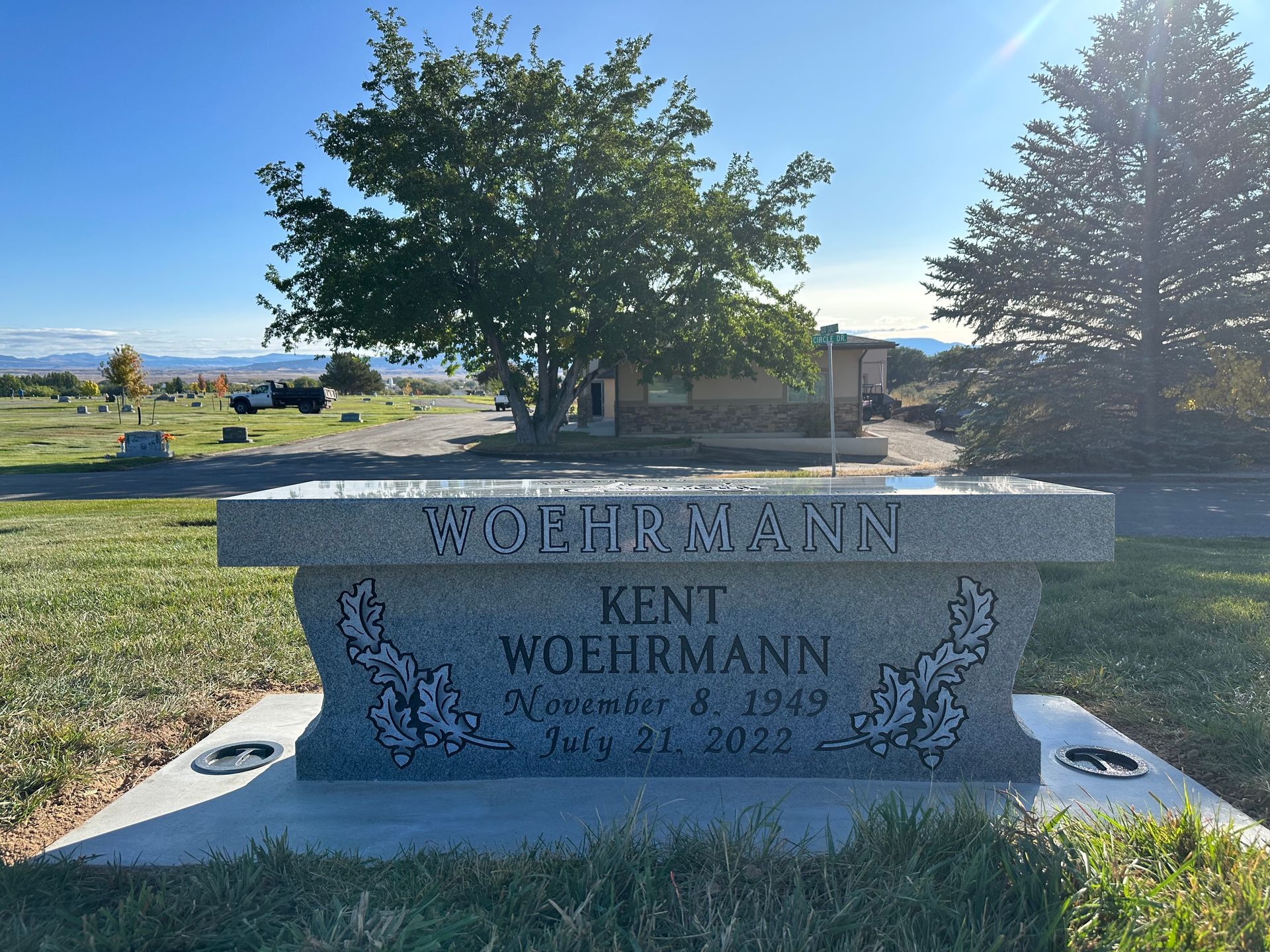Grave marker with WOEHRMANN on a bench. It memorializes Kent Woehrmann, born Nov 8, 1949, died July 21, 2022.