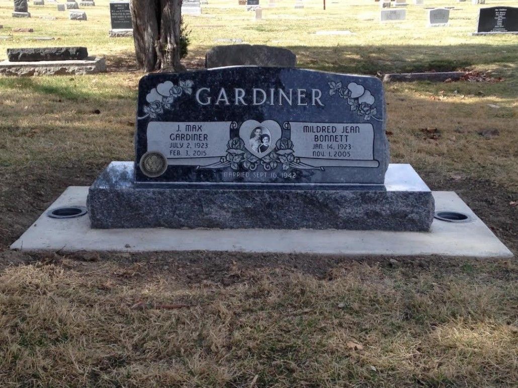 Headstone in a cemetery, with the name GARDINER. It has the names of two people and a heart in the middle.
