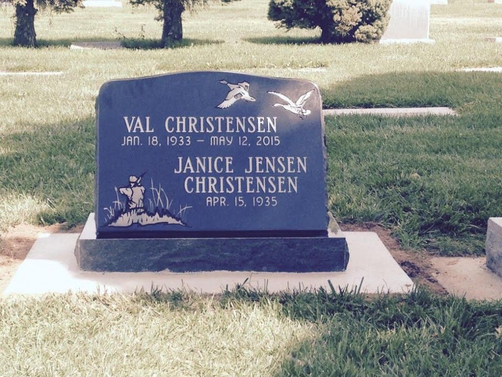 Tombstone of Val Christensen (1933-2015) and Janice Jensen Christensen (1935- ). Black headstone in grassy cemetery.