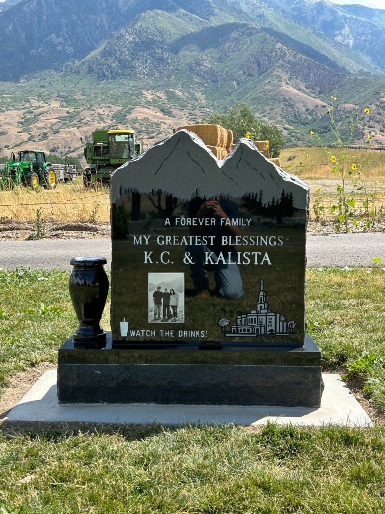 Black granite tombstone with mountains, My Greatest Blessings inscription, and photos.
