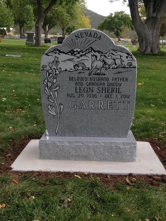 Gray headstone in a cemetery, Nevada above mountains, text for Leon Sherril Garrett.
