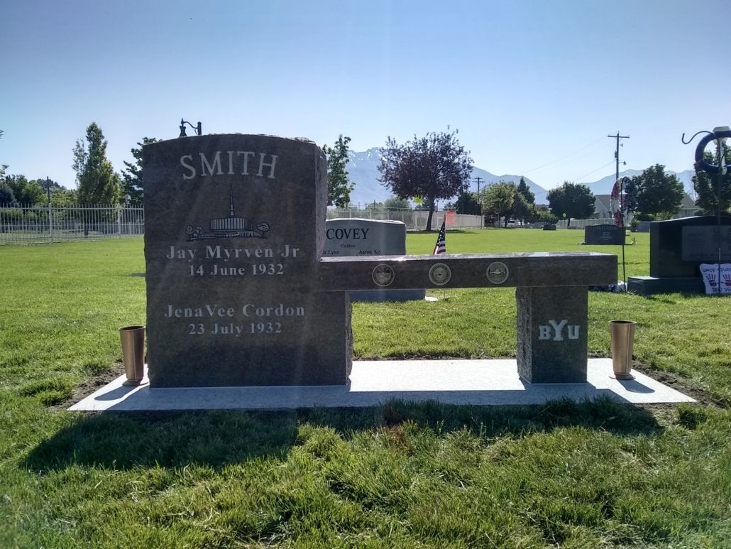 Grave monument for Smith, a bench, with dates, grass, and a sunny outdoor cemetery setting.