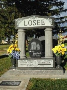 Grave marker for the Losee family. Gray stone with columns, includes dates, names, and an engraving of a temple.